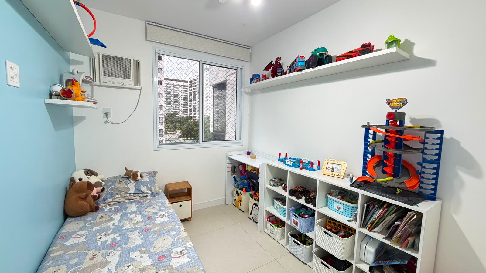 Segundo quarto do apartamento com marcenaria planejada e vista externa