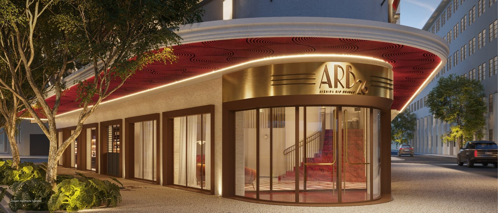 Entrada e loja no térreo do ARB 26, com fachada art déco iluminada à noite