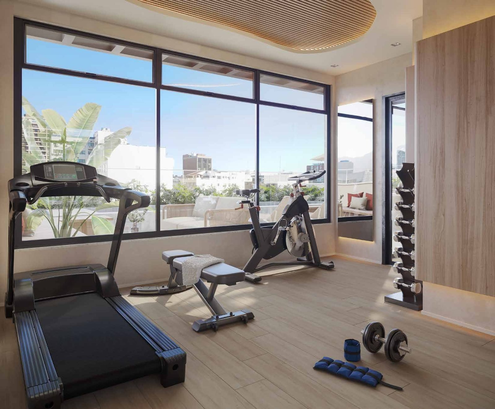 Espaço fitness do Be.in.Rio Barão da Torre, com esteira e vista para a cidade