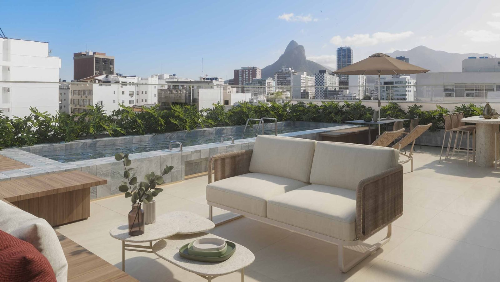Lounge do rooftop do Be.in.Rio Barão da Torre, com sofás e vista para o Dois Irmãos