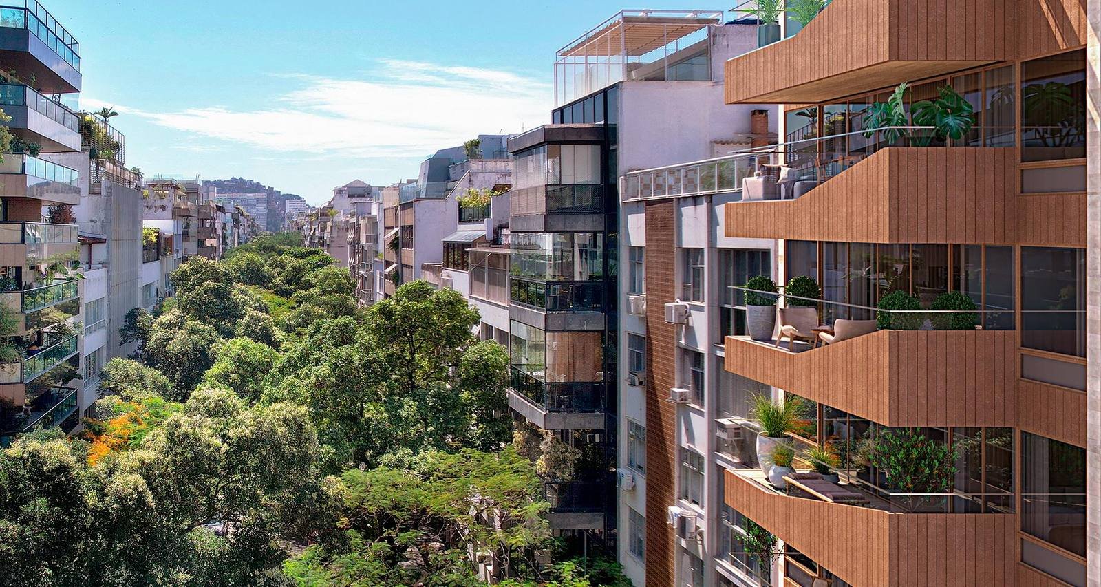 Fachada do Tempo Ipanema na Rua Nascimento Silva, vista entre a vegetação da rua
