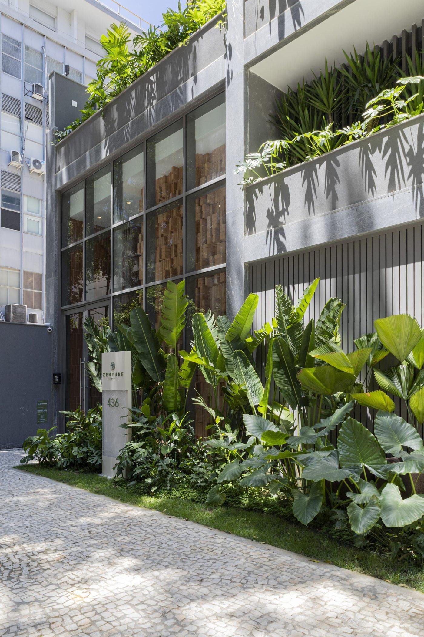 Fachada lateral do Zenture, com jardim vertical e passagem lateral